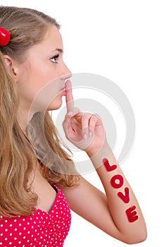 Pretty teenage girl showing silence sign