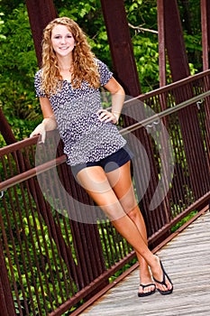 Pretty Teenage Girl Standing on a Bridge