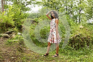 Pretty teenage girl in summer dress in front of ruins