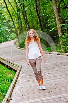 Pretty Teenage Girl Walking in a Park