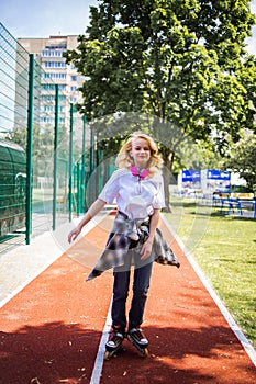 Pretty Teenage Girl Wearing Roller Skaters On The Road In Summe Park.