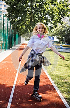 Pretty Teenage Girl Wearing Roller Skaters On The Road In Summe Park.