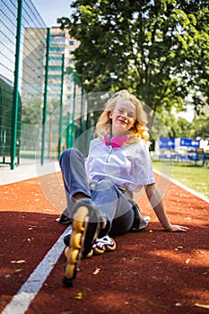 Pretty Teenage Girl Wearing Roller Skaters On The Road In Summe Park. photo