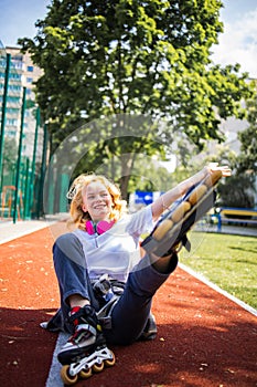 Pretty Teenage Girl Wearing Roller Skaters On The Road In Summe Park. photo