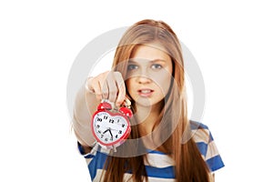 Pretty teenage woman with alarmclock