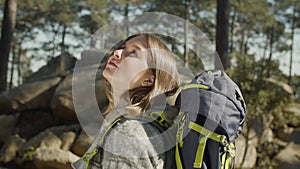 Pretty teenaged girl hiking in woods