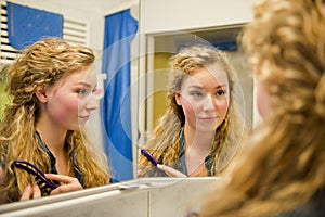 Pretty teenager combing her hair