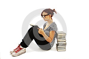 Pretty teenager girl sit on floor and reading book