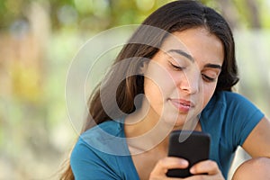 Pretty teenager girl texting in a smart phone