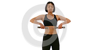 Pretty Thai Asian sportswoman is lifting dumbell in both arm standing upraise or V raise posture. Weight exercise cardio workout i