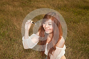 Pretty Thai woman happy with the magnifying glass .