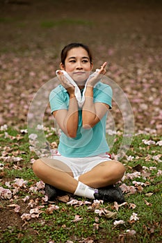 Pretty Thai woman rest exercise in the park .