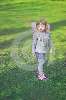 Pretty toddler girl with butterfly wings