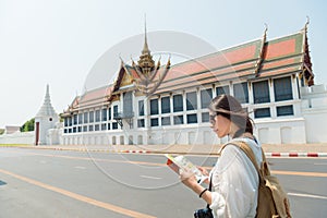 Pretty tourist woman reading travel guidebook photo