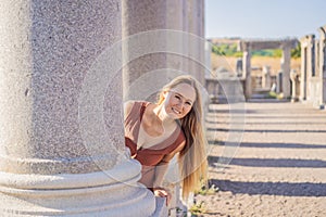 Pretty tourist woman at the ruins of ancient city of Perge near Antalya Turkey photo