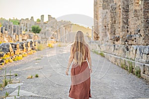 Pretty tourist woman at the ruins of ancient city of Perge near Antalya Turkey photo