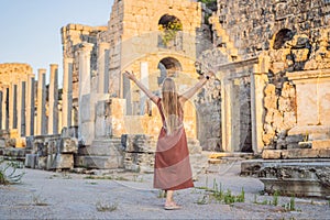 Pretty tourist woman at the ruins of ancient city of Perge near Antalya Turkey photo