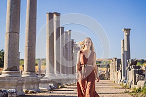 Pretty tourist woman at the ruins of ancient city of Perge near Antalya Turkey photo