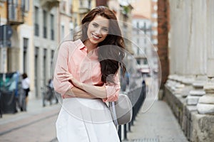 Pretty trendy girl posing at the city in Europe,