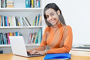 Pretty turkish female student learning at computer