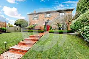 Pretty two story brick house with stoned walkway