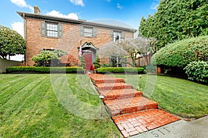 Pretty two story brick house with stoned walkway