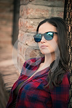 Pretty urban girl portrait with sunglasses in the city