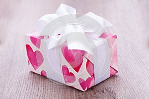 Pretty Valentines gift with hearts on the giftwrap