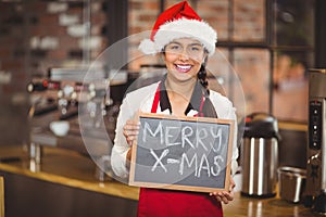 Pretty waitress with a chalkboard merry x-mas