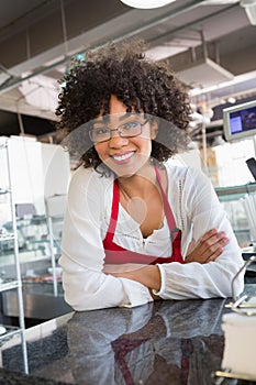 Pretty waitress with glasses leaning on counter