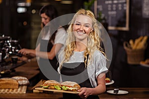 Pretty waitress holding a tray with sandwiches photo