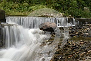 Pretty waterfall on rock stones