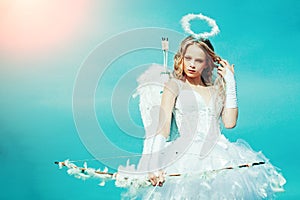 Pretty white little girl as the cupid with a bow and arrow congratulating on St Valentines day. Cherub girl