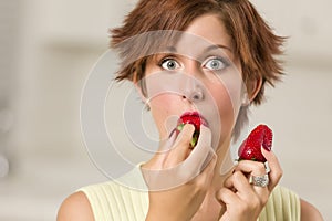 Pretty Wide-eyed Woman Biting Strawberry