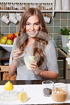 Pretty woman adding cane sugar to tea photo