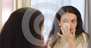 pretty woman applying everyday makeup at home