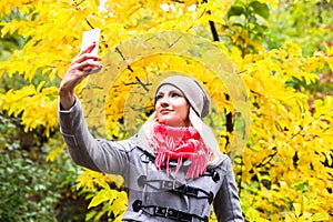 Pretty woman on backdrop of autumn leaves - seasonal relax concept