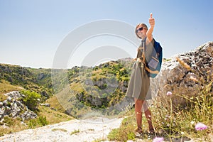 Pretty woman with backpack.hiking near Matera, Basilicata region. Italy