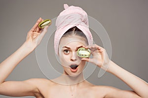 pretty woman bare shoulders skin care kiwi in hand cropped view