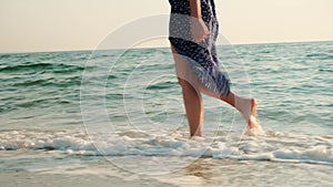 Pretty woman at the beach. Happy girl enjoying summer morning walking near the sea