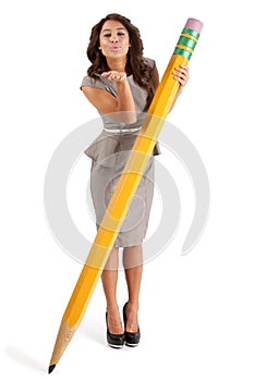 Pretty woman with a big pencil blowing a kiss.