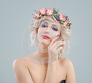 Pretty woman with blonde hair, makeup and flowers crown