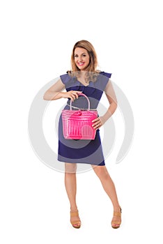 Pretty woman in blue dress posing with bright tote bag.Isolated.