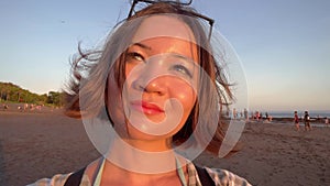 Pretty woman with bob-cut hair style enjoying sunset on a sandy beach. Female person on seaside. Korean girl on ocean