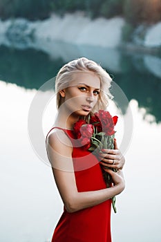 Pretty woman with a bouquet of peony. On the background of the s