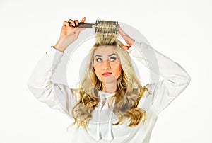 Pretty woman brushing hair isolated on white background. Long hair. Curling Your Hair Much Easier. Hot curling brush