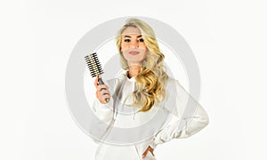 Pretty woman brushing hair isolated on white. Long hair. Hair care. Hairdresser salon. Professional equipment. Easy