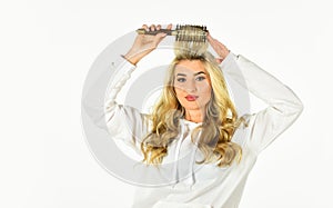 Pretty woman brushing hair  on white background. Long hair. Hair care. Hairdresser salon. Professional equipment