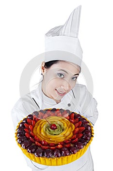 Pretty woman chef holding a cake