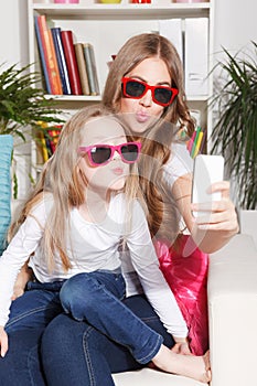 Pretty woman and child taking a selfie